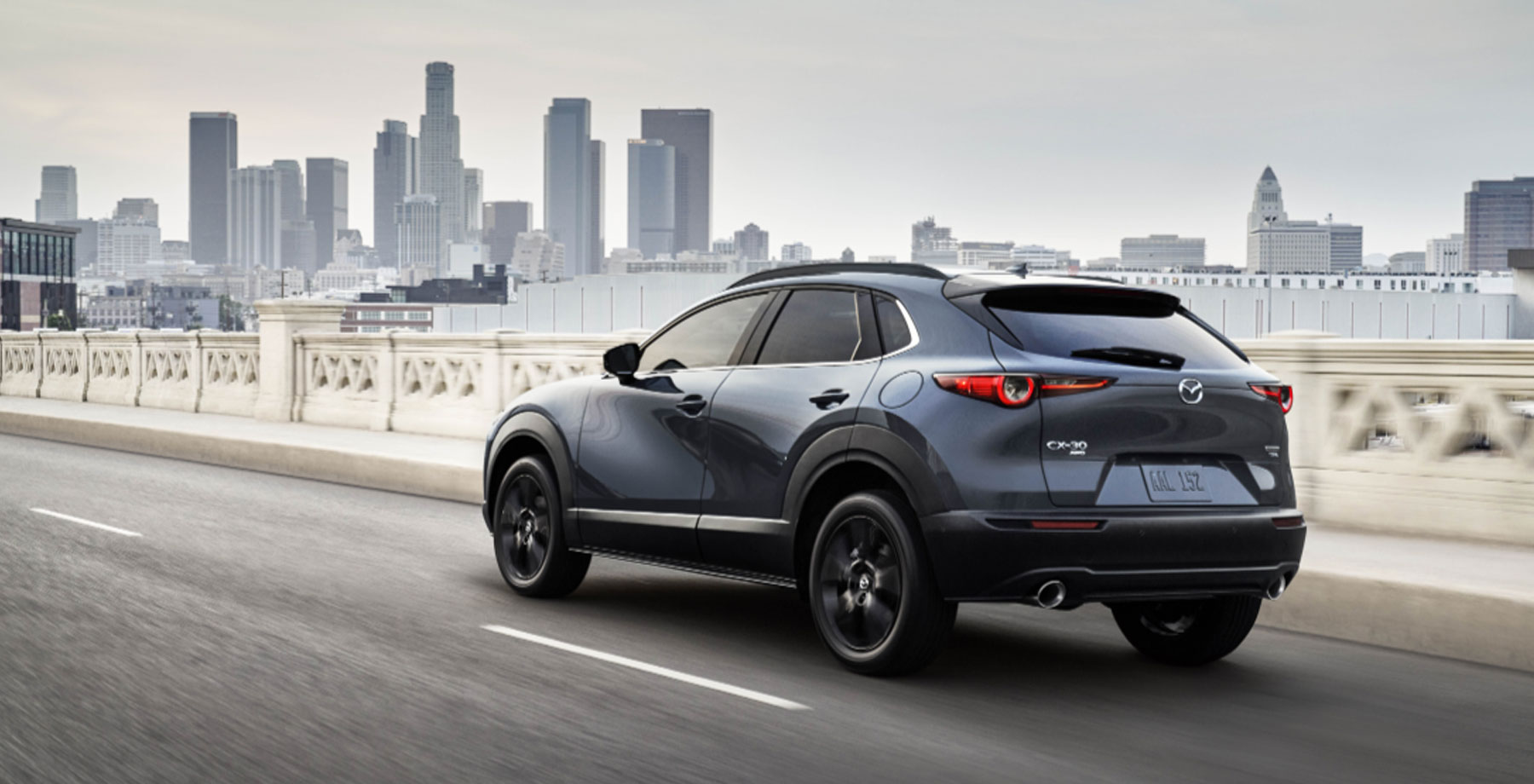 2025 Mazda CX-30, gray in color, driving on a highway.